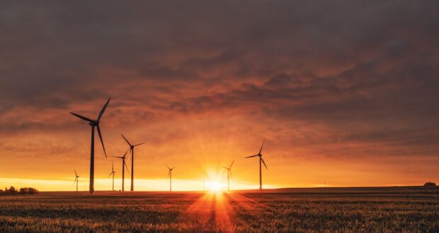 windmill on grass field during golden hour