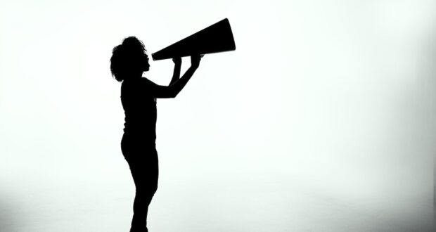 silhouette of woman holding rectangular board