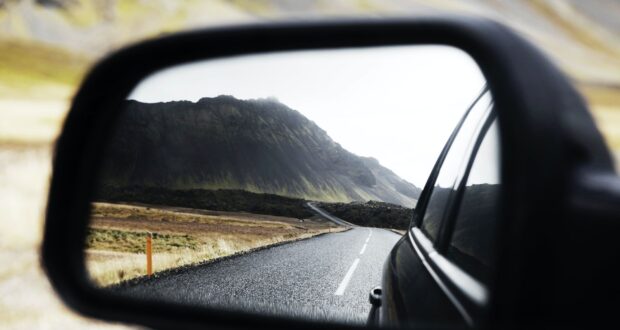 black wing mirror showing road