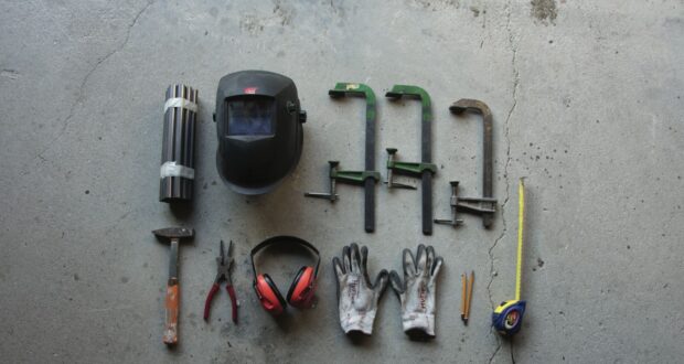 assorted hand tools on gray concrete floor