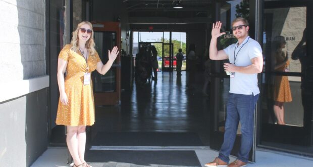 two man and woman standing on doorway