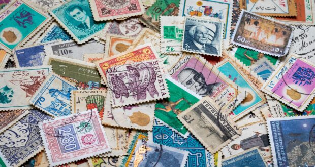 assorted postage stamps on blue and white textile