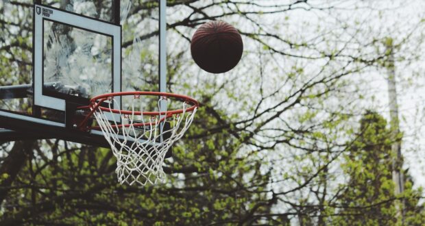 time lapse photography of ball about to shoot on basketball hoop