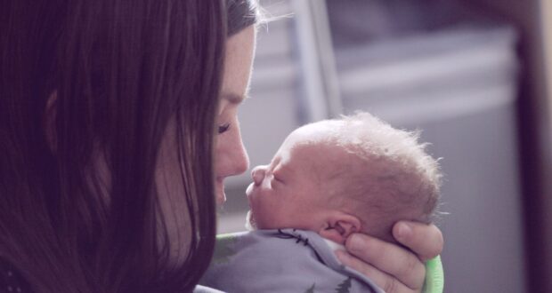 woman kissing baby