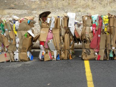 brown cardboard boxes on gray asphalt road during daytime