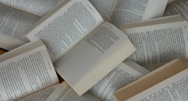 white and brown book on brown woven surface